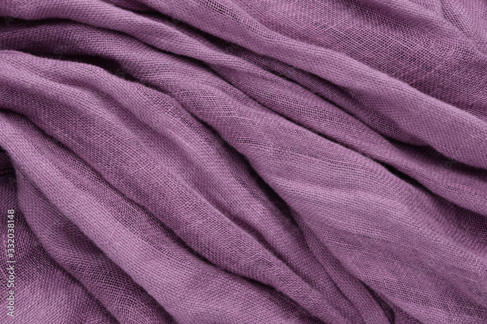 Fototapeta premium Purple draped linen fabric or scarf background.