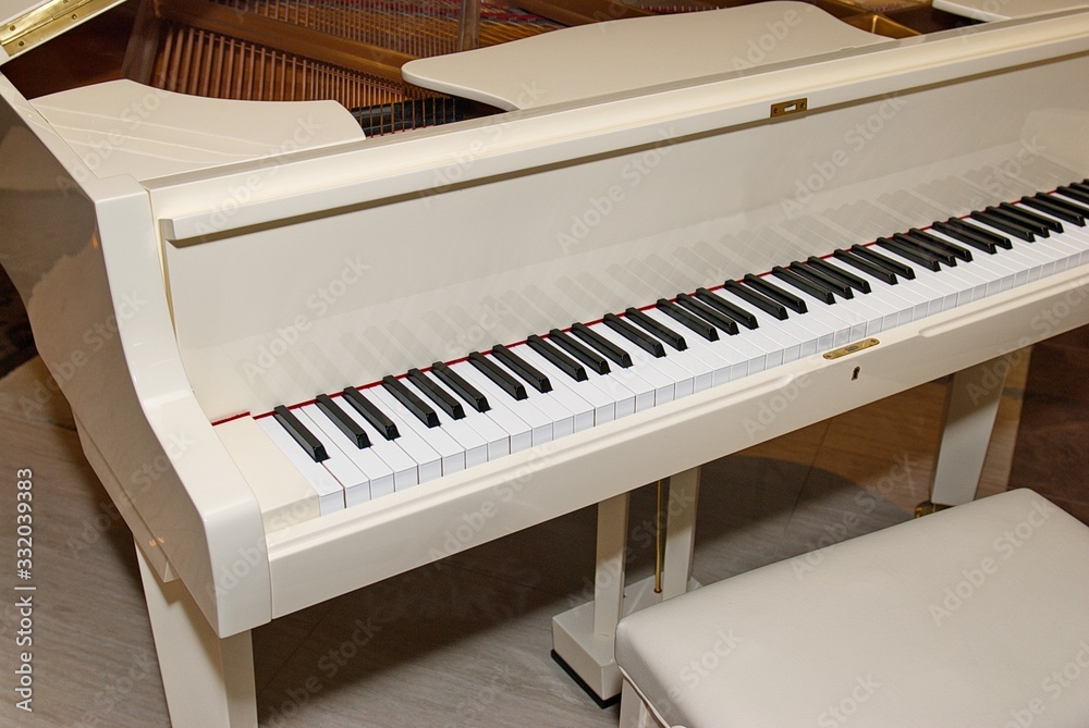 Piano with a chair in the hall. White piano. Piano with a chair in the hall. White piano.