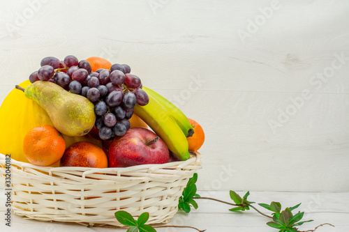 fruits and vegetables in a basket isolated on white photo