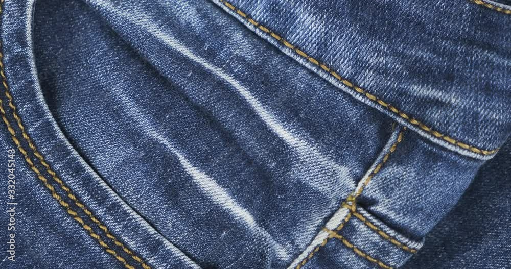 Rotation. Close-up of jeans elements. Jeans pocket and seams close up view. Rotation. Close-up of jeans elements. Jeans pocket and seams close up view.