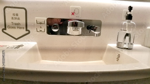Φωτογραφία Bathroom sink in a commercial airplane with personal cleaning products