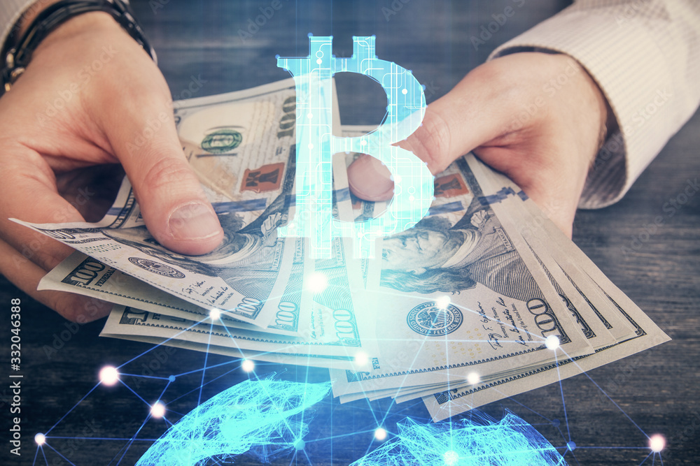 Multi exposure of blockchain theme drawing hologram and USA dollars bills and man hands. Business concept. Multi exposure of blockchain theme drawing hologram and USA dollars bills and man hands. Business concept.