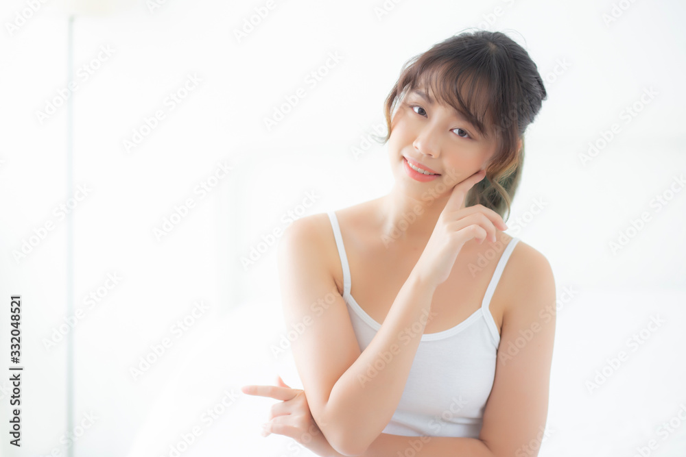 Portrait of beautiful young asian woman smile while wake up healthy and wellness with sunrise at morning in the bedroom, asia girl skin care with happy with fresh, lifestyle and relax concept. Portrait of beautiful young asian woman smile while wake up healthy and wellness with sunrise at morning in the bedroom, asia girl skin care with happy with fresh, lifestyle and relax concept.