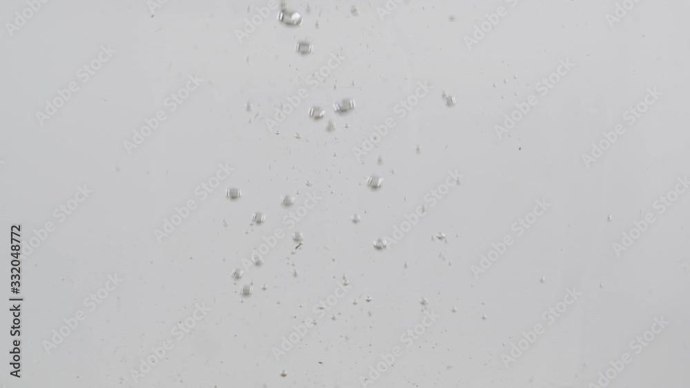 Whole kiwis falls into the water with bubbles. Slow motion. Whole kiwis falls into the water with bubbles. Slow motion.