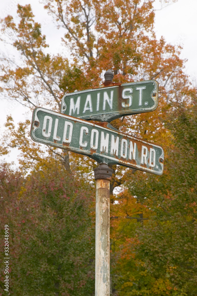 Main Street USA and Old Common Road sign in autumn, western Massachusetts, New England