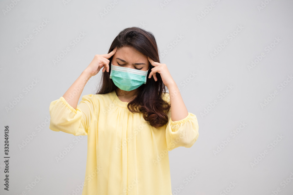 Portrait of a sick headache young woman asian wearing medical mask. Pandemic 2019 Coronavirus 2019-nCoV Concept. Portrait of a sick headache young woman asian wearing medical mask. Pandemic 2019 Coronavirus 2019-nCoV Concept.