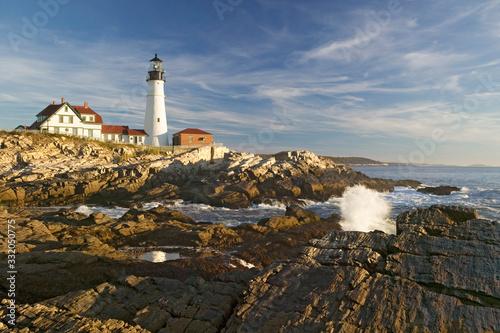 Sunrise view of Portland Head Lighthouse and ocean wave, Cape Elizabeth, Maine