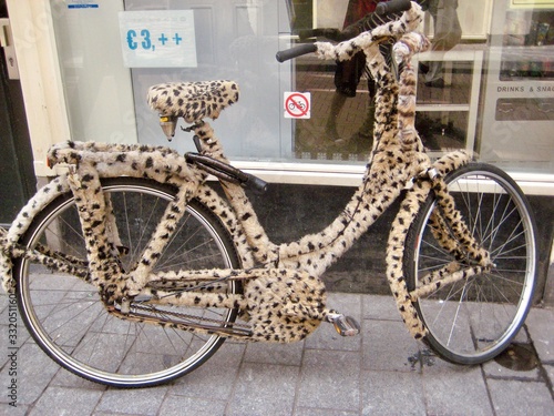 crazy leopard bicycle on the street, bicyle with leopard skin, mobility and transportation, amsterdam streets, amsterdam bycicle, amsterdam