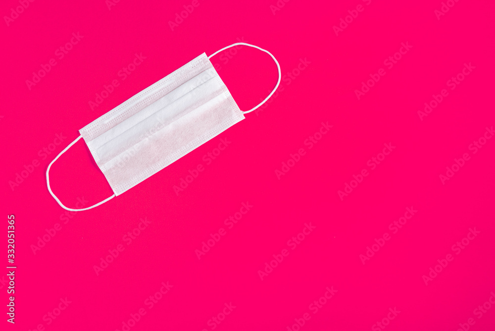 Surgical mask over minimalist orange background Surgical mask over minimalist orange background