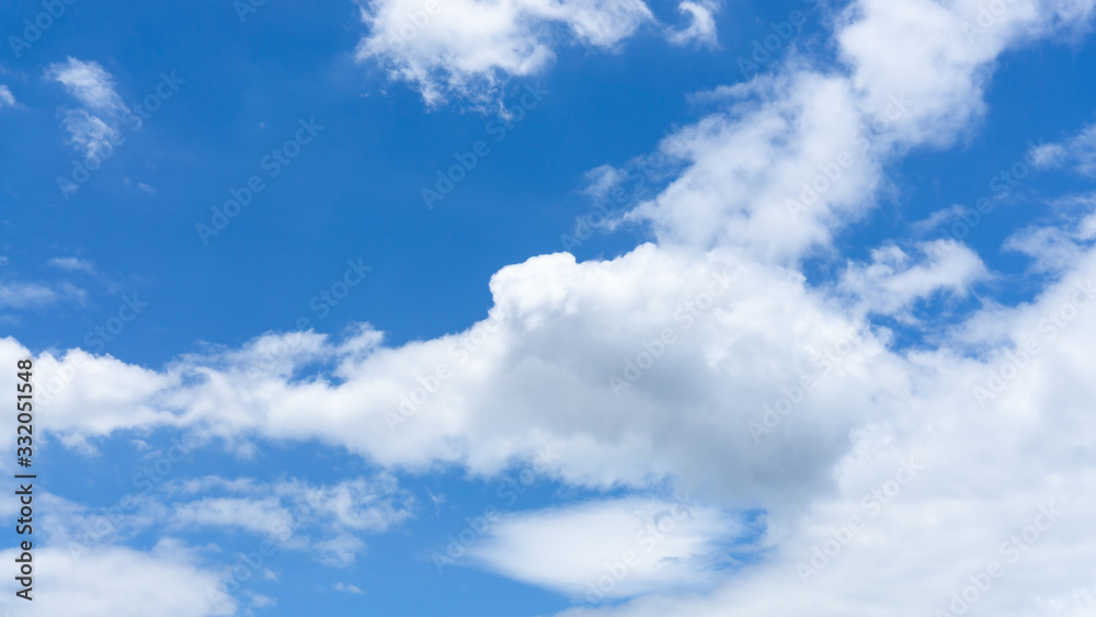 Upward skyscape view to cloudscape, shape of white fluffy clouds look like the eagle flying on vivid blue sky in a suny day Upward skyscape view to cloudscape, shape of white fluffy clouds look like the eagle flying on vivid blue sky in a suny day