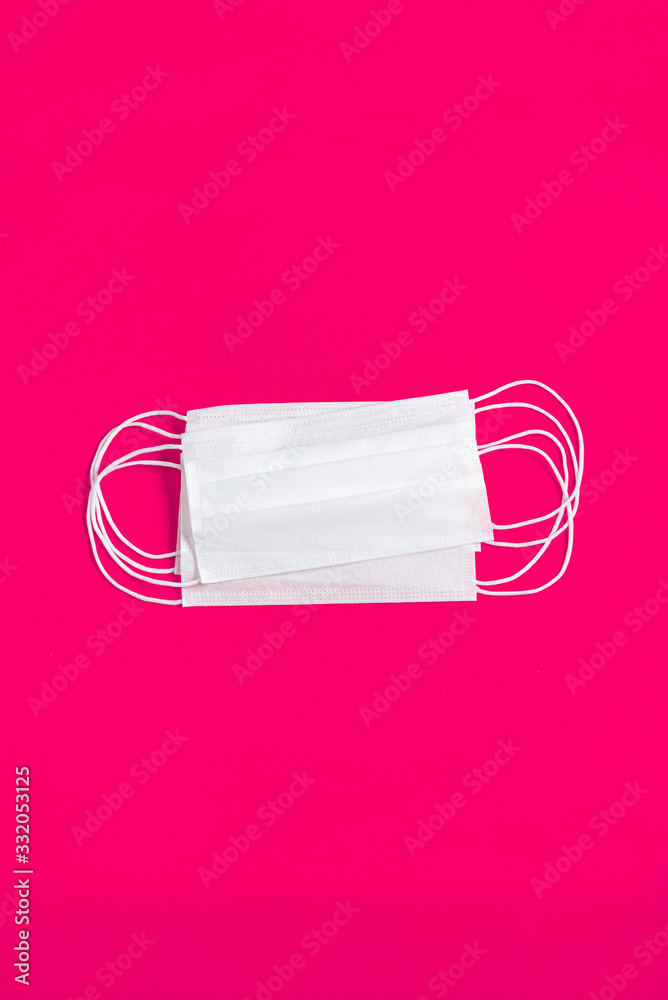 Surgical mask over minimalist orange background