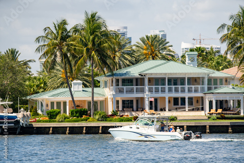 People boating tour by mansions in Fort Lauderdale FL USA