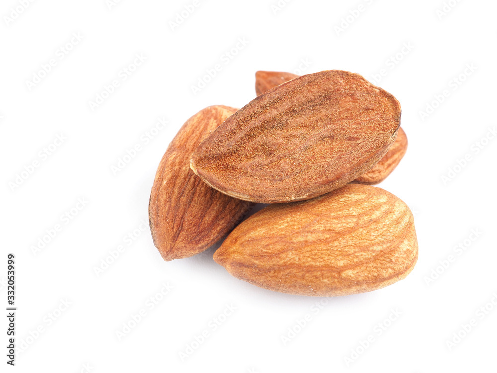 Close up a pile of almonds seeds isolated on a white background. Healthy food.. Close up a pile of almonds seeds isolated on a white background. Healthy food..