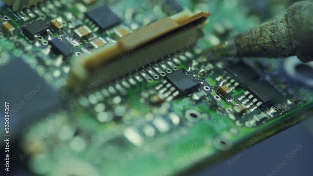 Soldering is done on the microchips in the factory with a soldering machine. electronic working hands.3. Soldering is done on the microchips in the factory with a soldering machine. electronic working hands.3.