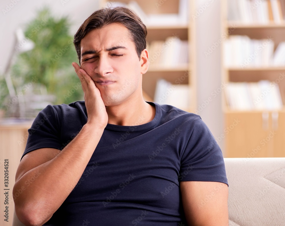 Fototapeta premium Young handsome man suffering from pain