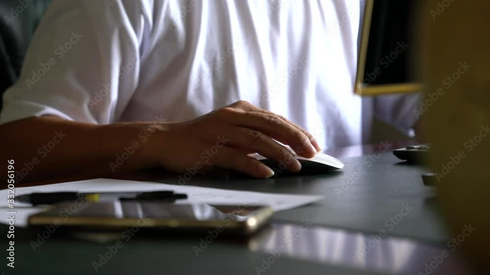 Working on the computer at home. Focus on the fingers clicking the mouse, surfing or browsing. Working on the computer at home. Focus on the fingers clicking the mouse, surfing or browsing.