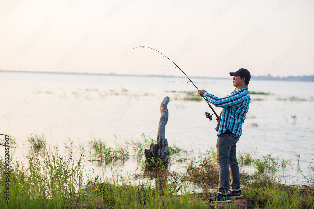 Office man self quarantine in with the nature by fishing in the lake. Quarantine concept Office man self quarantine in with the nature by fishing in the lake. Quarantine concept