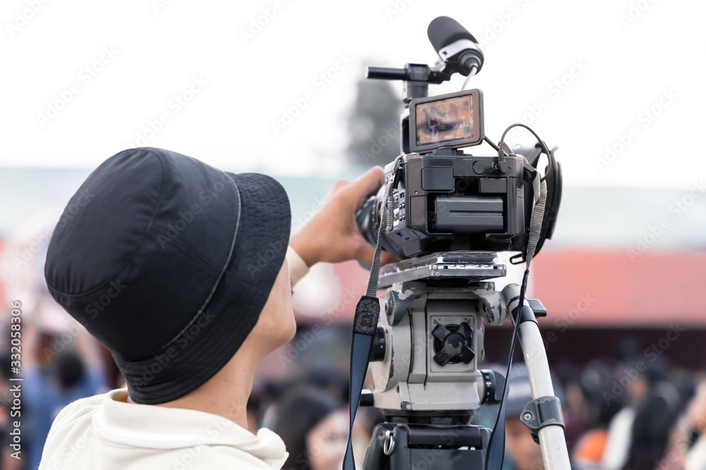 Professional digital video camera technician. Videographer with equipment at event. Professional digital video camera technician. Videographer with equipment at event.
