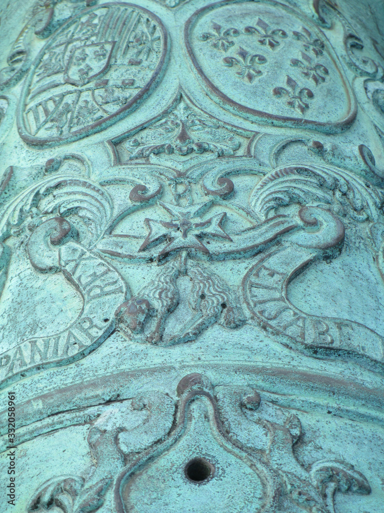 scroll and engraving on aged cannon