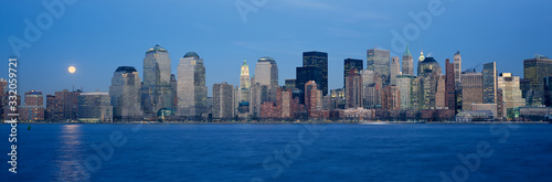 Panoramic view of full moon rising over lower Manhattan skyline, NY where World Trade Towers were located © spiritofamerica