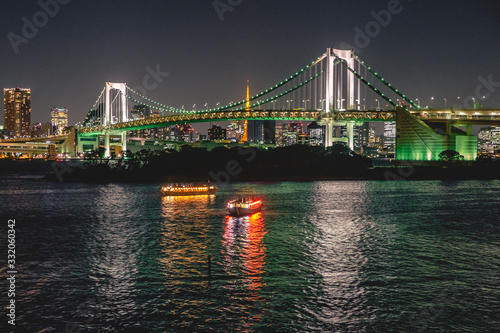 Tokyo cityscape by night, with Sumida river with reflections, Rainbow bridge and Tokyo Tower with lights, Japan photo