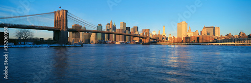Panoramic view of Brooklyn Bridge and East River at sunrise with New York City  where World Trade Towers were located  NY