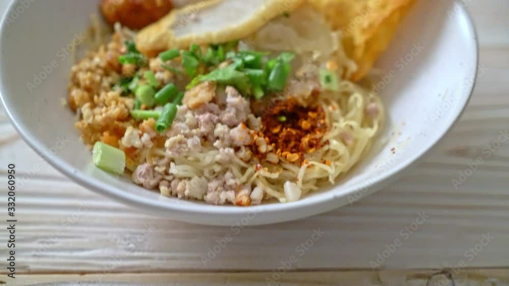 spicy noodles with fish ball and minced pork (Tom Yum Noodles) - Asian food style spicy noodles with fish ball and minced pork (Tom Yum Noodles) - Asian food style