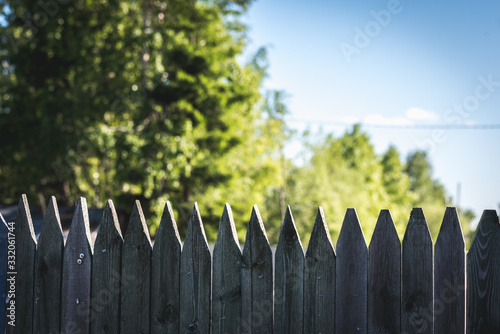 Wooden fence made of stockade to protect the territory.