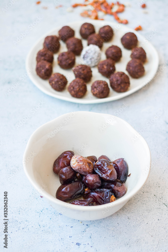 Iranian dates and protein energy balls with cocoa, carob, chocolate, coconut, oatmeal. Dark vegan truffles sweets. Healthy dessert Iranian dates and protein energy balls with cocoa, carob, chocolate, coconut, oatmeal. Dark vegan truffles sweets. Healthy dessert