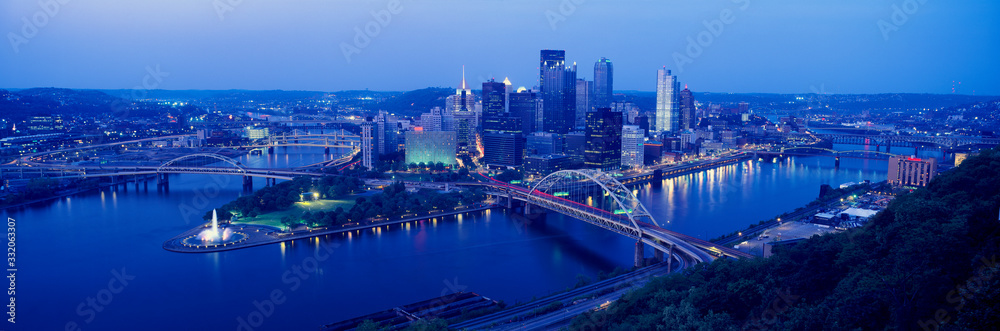 Panoramic evening view of Pittsburgh, PA with West End Bridge, and Allegheny, Monongahela and Ohio Rivers
