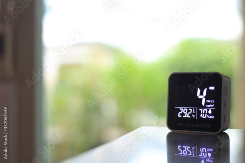 air quality sensor placing on a table indoor. sensor found small amount of air pollution of PM 2.5 the poisonous harmful particulate matter invisible dust from open field fire. man-made disasters.