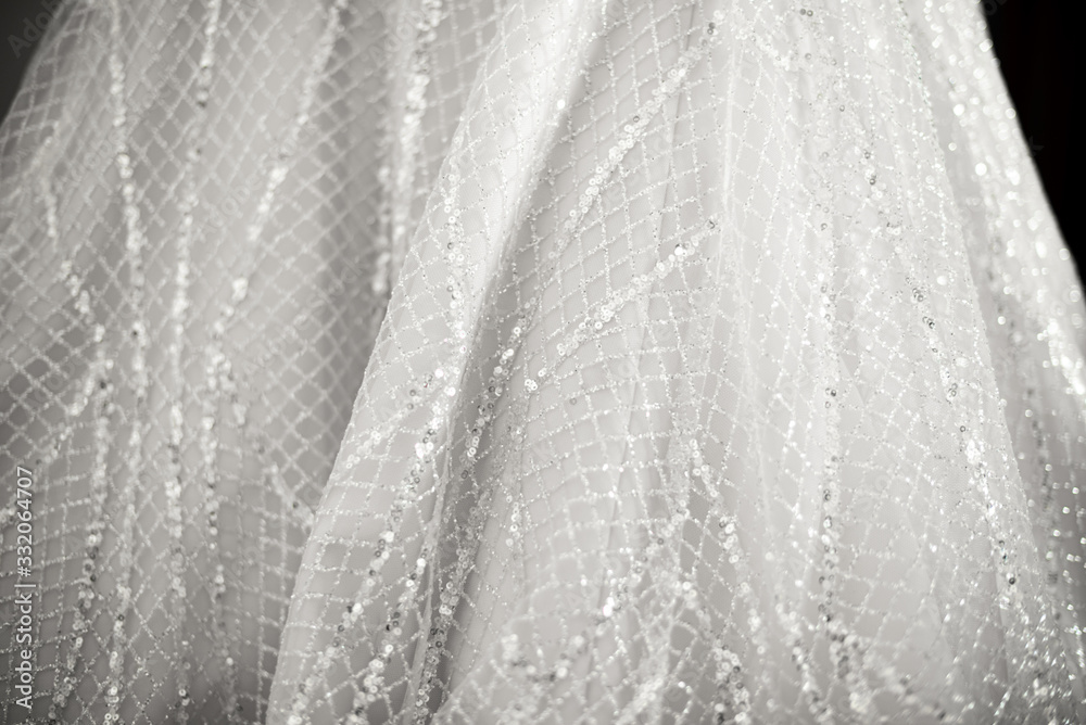 Fototapeta Close up of a wedding dress or bridal gown which is the dress worn by the bride during a wedding ceremony.