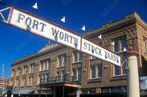 Banner at the Fort Worth Stock Yards with historic hotel, Ft. Worth, TX photo