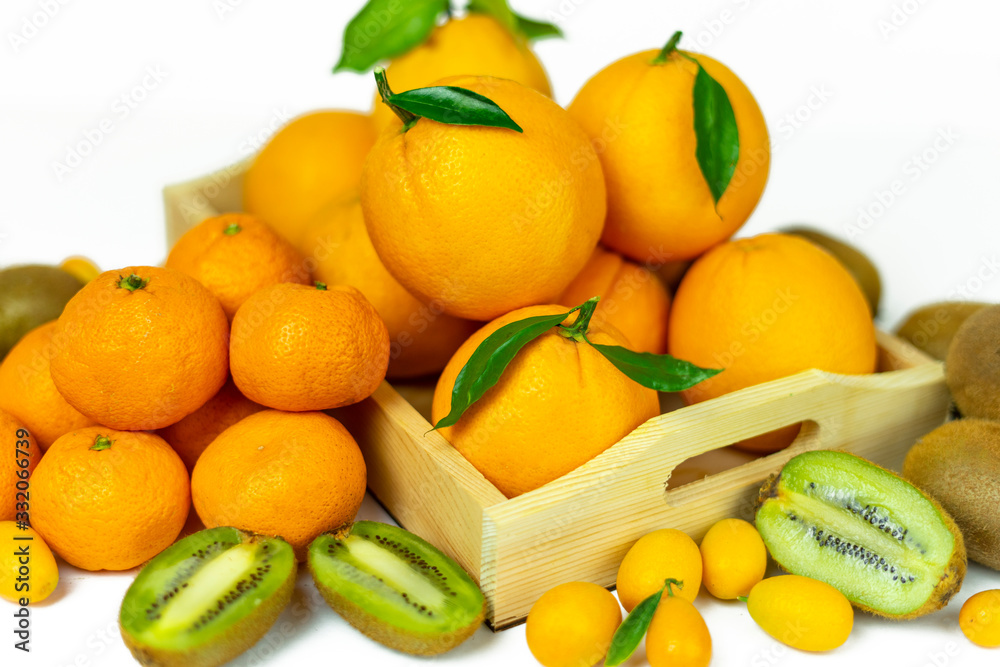 Tropical fruits in bulk: orange, mandarin, kumquat, kiwi. Fresh fruits, food on a white background.