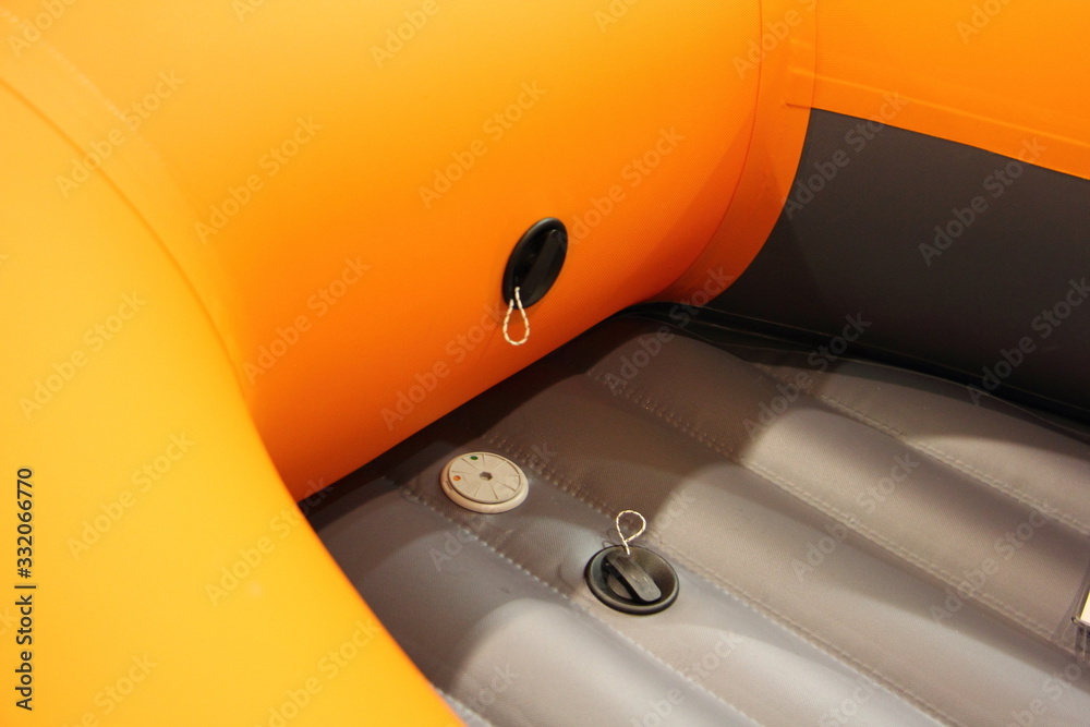Modern orange Inflatable PVC boat inlate and pressure protection valves close up