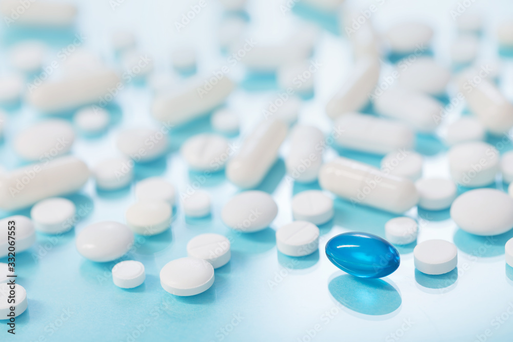 white and blue pills on  blue background