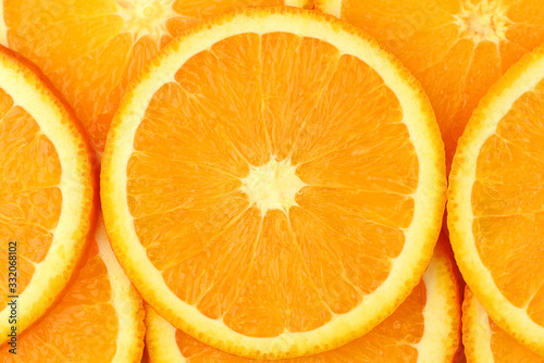 Fresh orange slices close up background. Juicy sun orange macro shot. 