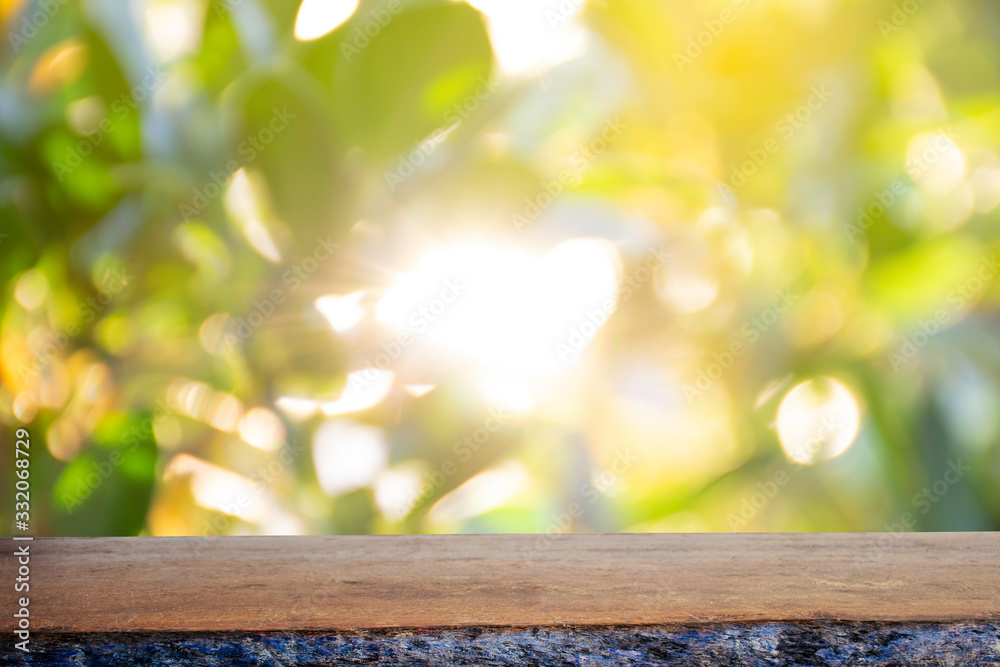 Display the product on a wooden table. The bokeh background from the sun is passing through the leaves