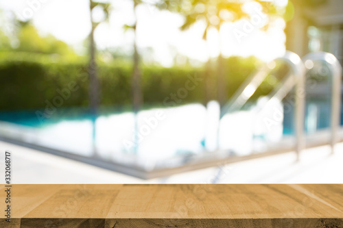 display products on the table, background beside the pool behind the accommodation
