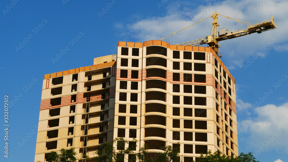 Construction building and construction crane on blue sky background