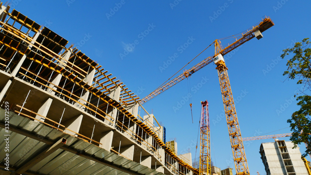 Construction crane near the building under construction