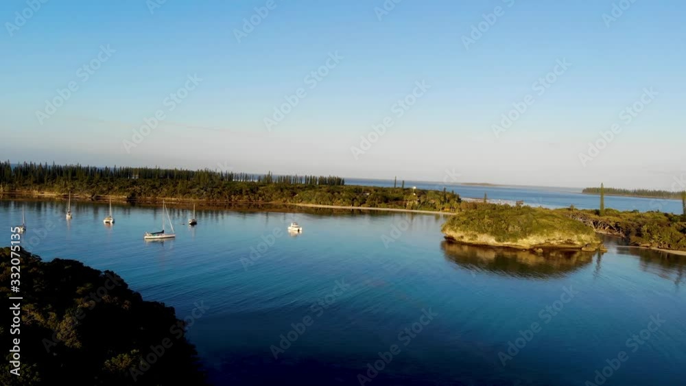 Surrounded by plants of coconut trees and column pines, the beach of Kanumera bay is ideal for snorkeling in the scenario of the Isle of Pines in New Caledonia.