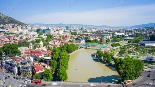 Hyperlapse flight over of the old town on Sololaki hill, crowned with Narikala fortress, the Kura river and cars traffic in Tbilisi, Georgia.