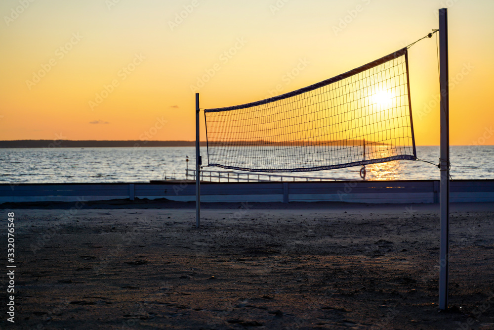 Sillhouette of a volleyball net against sunset on the beach Sillhouette of a volleyball net against sunset on the beach