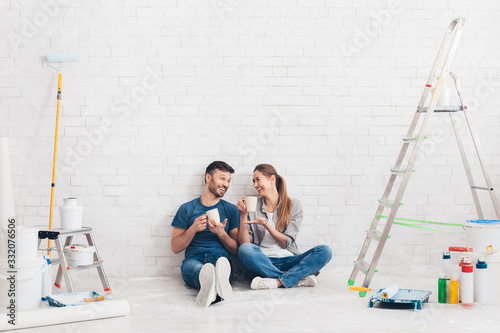 Young couple doing a repair in new home and relaxing