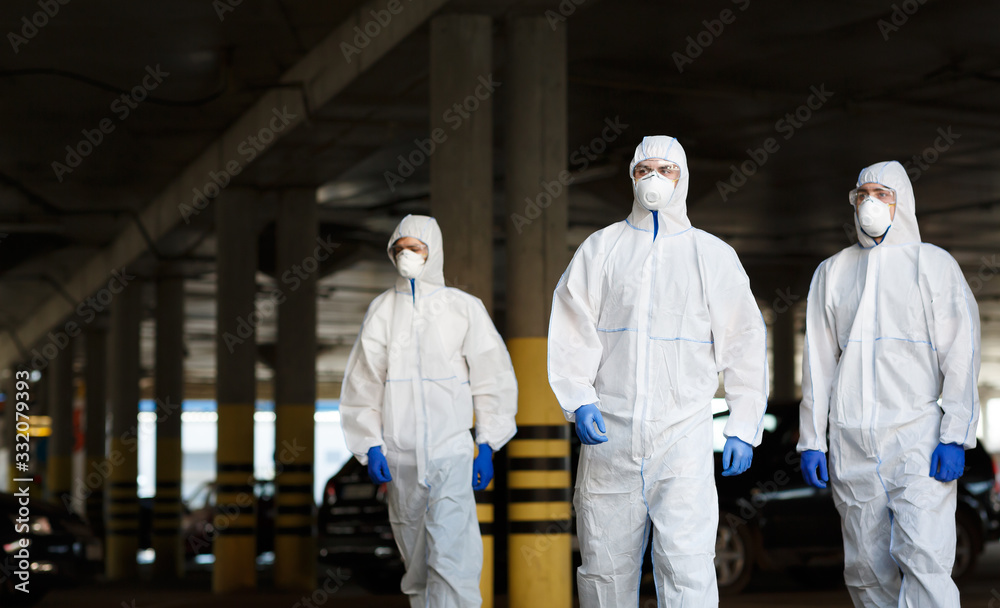 Doctors in virus protective suits on duty on public parking