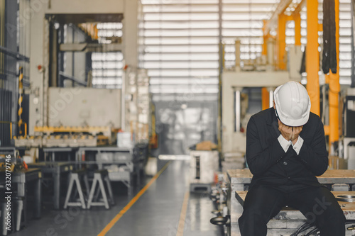 Entrepreneur feel Stressful depressed situation in factory.Unemployed Jobless People Crisis who Recession.Senior worker despair low economic crisis,business failure or government failed manage economy photo