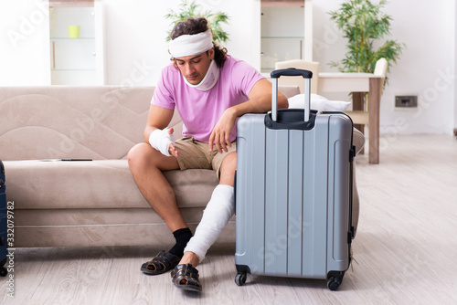 Young injured man preparing for the trip photo