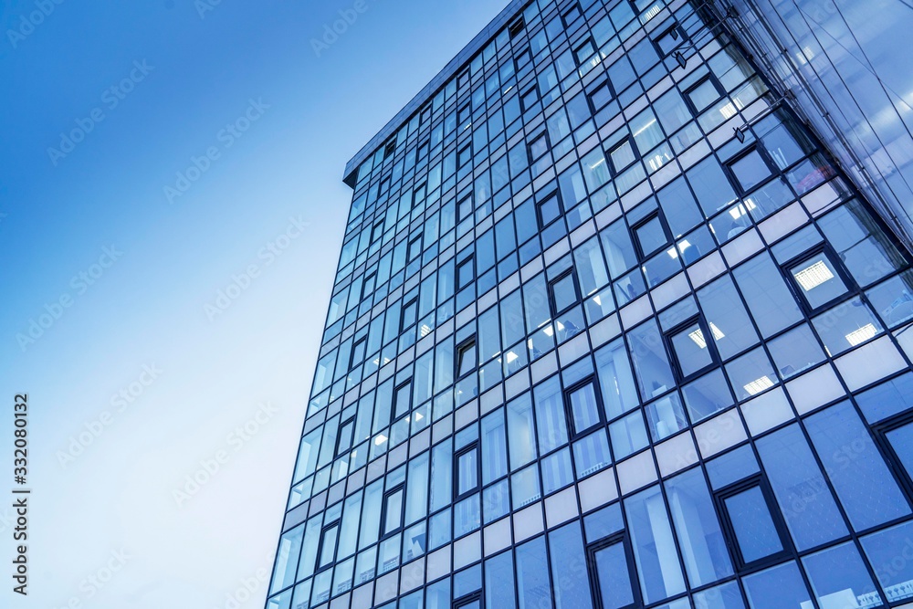 glass building against the sky. Modern urban design glass building against the sky. Modern urban design