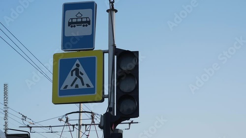 Flashing and changing traffic light color against the blue sky